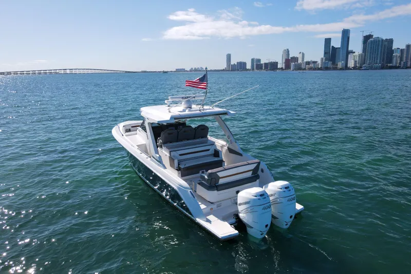 Slide: The Image of 2022 Tiara Yachts 34 LS on water with city skyline in background. - 5