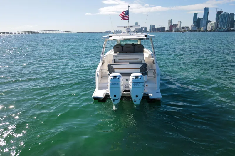 Slide: The Image of 2022 Tiara Yachts 34 LS on water with city skyline in background. - 7
