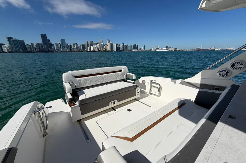 Slide: The Image of 2022 Tiara Yachts 34 LS on water with city skyline in background. - 9
