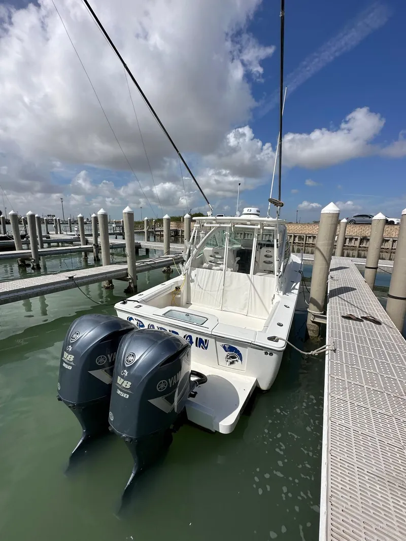 Slide: The Image of 2017 Albemarle Express boat docked with twin Yamaha engines under a partly cloudy sky. - 4