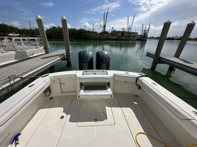 Slide: The Image of 2017 Albemarle Express boat at dock with twin engines, calm water, and clear sky. - 6