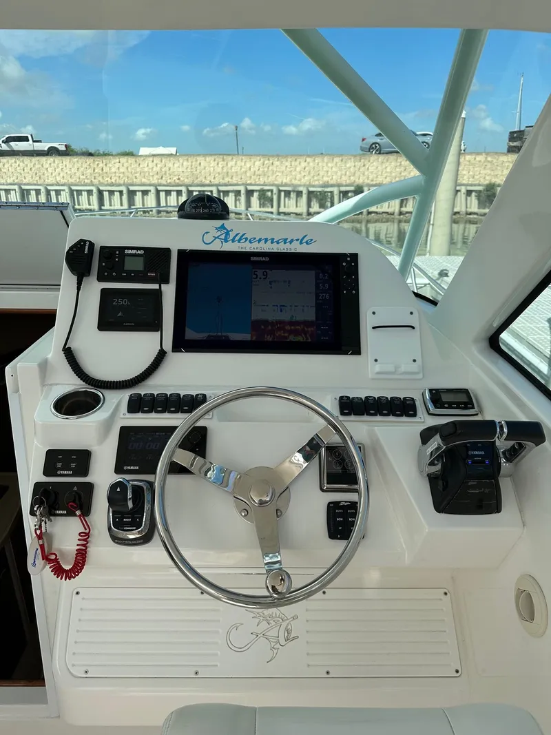 Slide: The Image of Helm of 2017 Albemarle Express boat with steering wheel and navigation controls. - 7