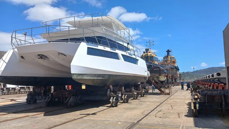 Slide: The Image of Dining setup on Leeuwin 55 yacht, featuring gourmet dishes and wine, 2024 model. - 30