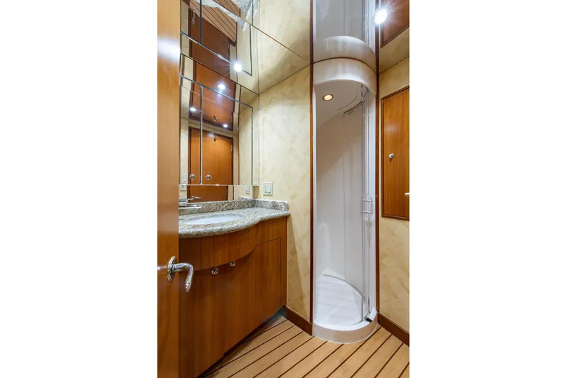 Slide: The Image of Luxurious bathroom in 2006 Hatteras 64 Convertible yacht with wood accents and modern fixtures. - 14