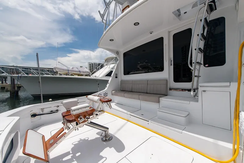 Slide: The Image of 2006 Hatteras 64 Convertible yacht deck with seating and fishing chair. - 23