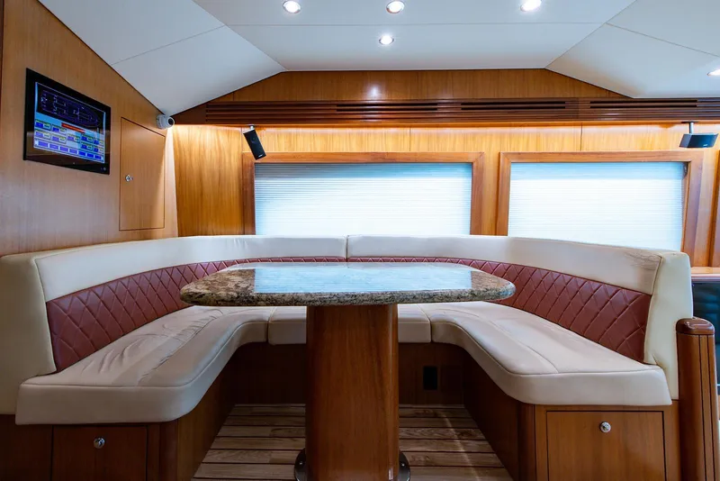 Slide: The Image of Luxurious interior of 2006 Hatteras 64 Convertible yacht with elegant seating and table. - 5