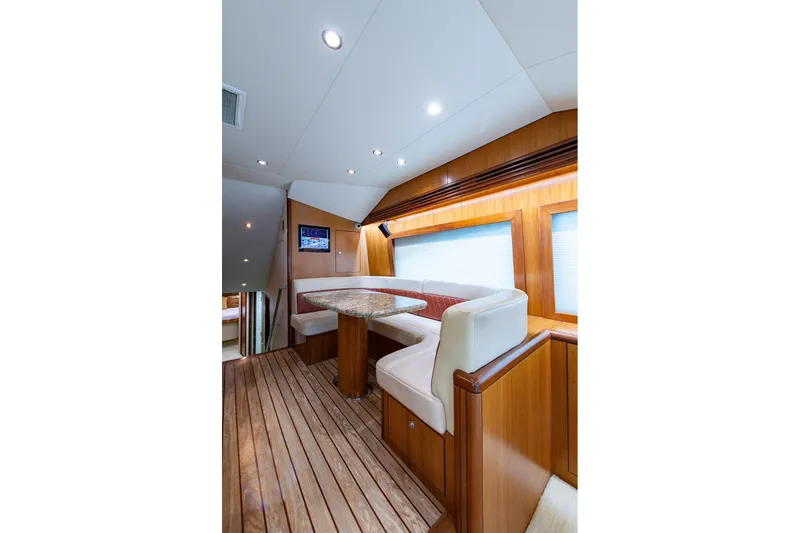 Slide: The Image of Luxurious interior of 2006 Hatteras 64 Convertible yacht with elegant wood finishes and seating. - 6