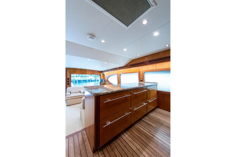 Slide: The Image of Luxurious interior of 2006 Hatteras 64 Convertible yacht with wooden cabinetry and modern design. - 8