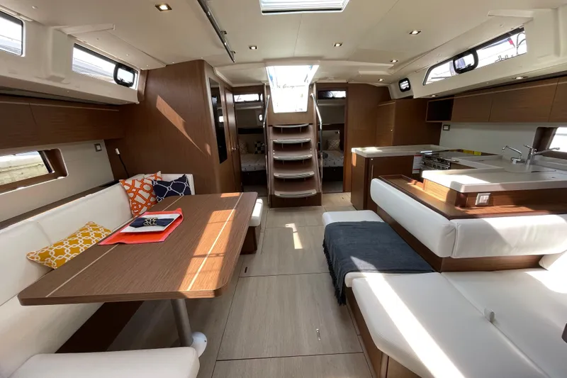 Slide: The Image of Luxurious interior of 2024 Beneteau Oceanis 51.1 yacht with modern furnishings and ample natural light. - 2