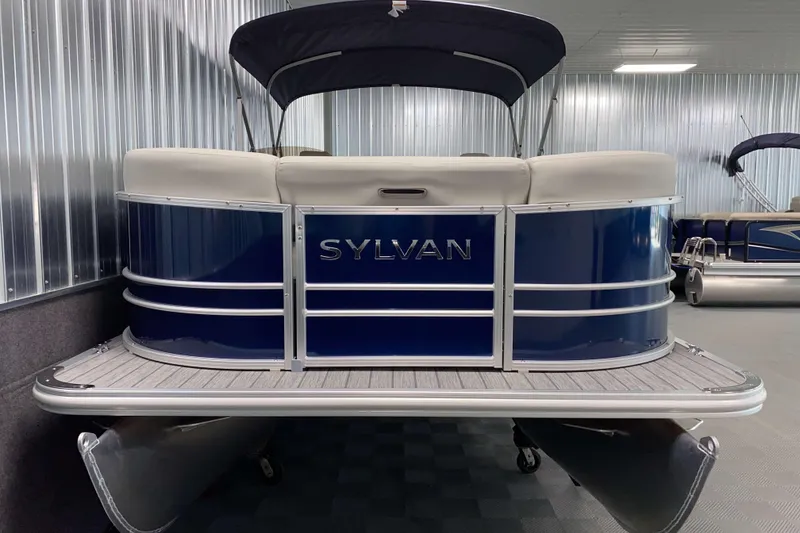 Slide: The Image of 2026 Sylvan Mirage 8522 LZ pontoon boat in showroom, featuring sleek blue design. - 15