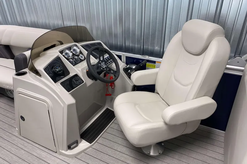 Slide: The Image of 2026 Sylvan Mirage 8522 LZ boat interior with steering console and plush captain's chair. - 7