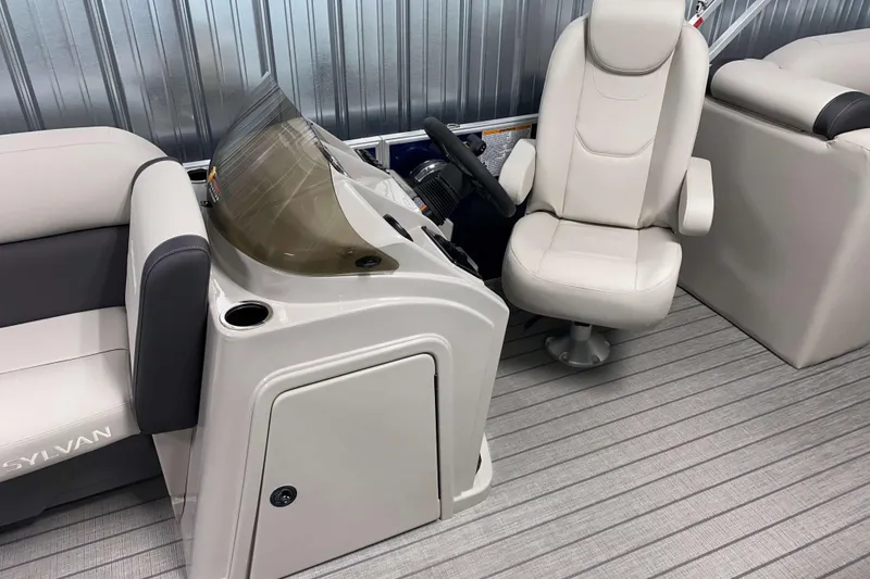 Slide: The Image of 2026 Sylvan Mirage 8522 LZ boat interior with helm and seating area. - 8