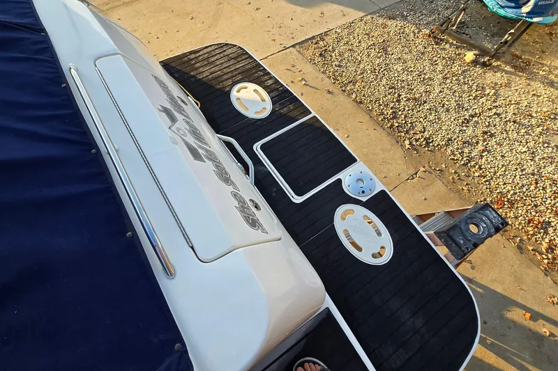 Slide: The Image of 2001 Sea Ray 310 Sundancer swim platform with black mat and stainless steel details. - 11
