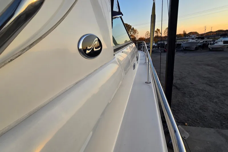 Slide: The Image of 2001 Sea Ray 310 Sundancer yacht side view at sunset in a marina. - 18