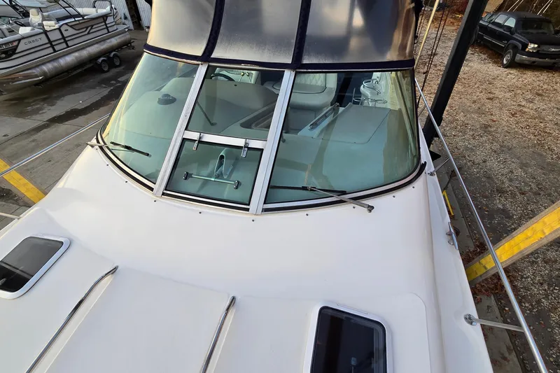 Slide: The Image of 2001 Sea Ray 310 Sundancer boat with windshield and deck view in marina. - 21
