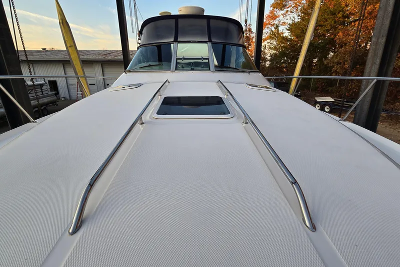 Slide: The Image of 2001 Sea Ray 310 Sundancer yacht deck with sleek design and chrome railings. - 22