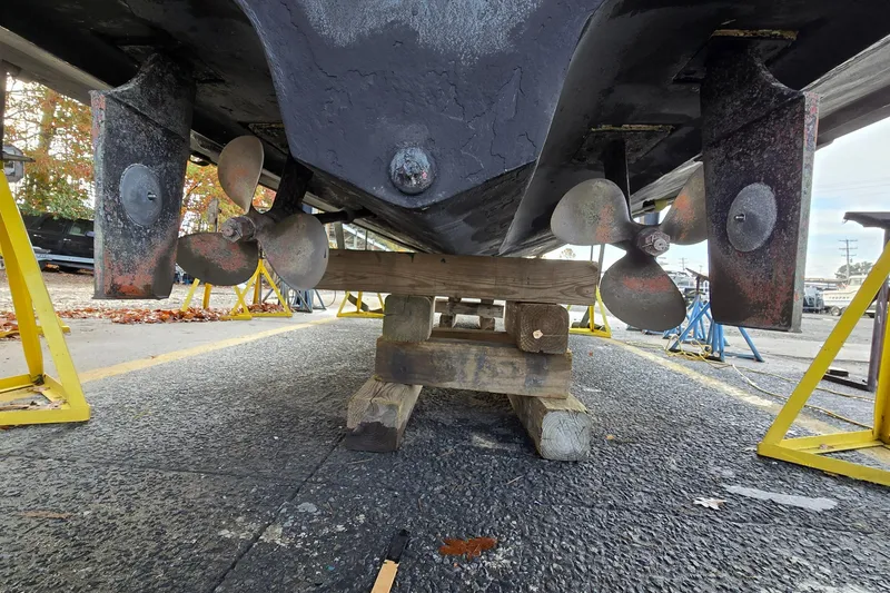 Slide: The Image of Underneath view of a 2001 Sea Ray 310 Sundancer on a boat stand. - 27