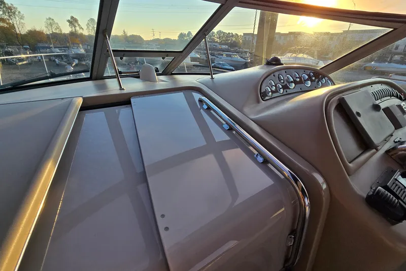 Slide: The Image of 2001 Sea Ray 310 Sundancer helm with sunset view through windshield. - 28