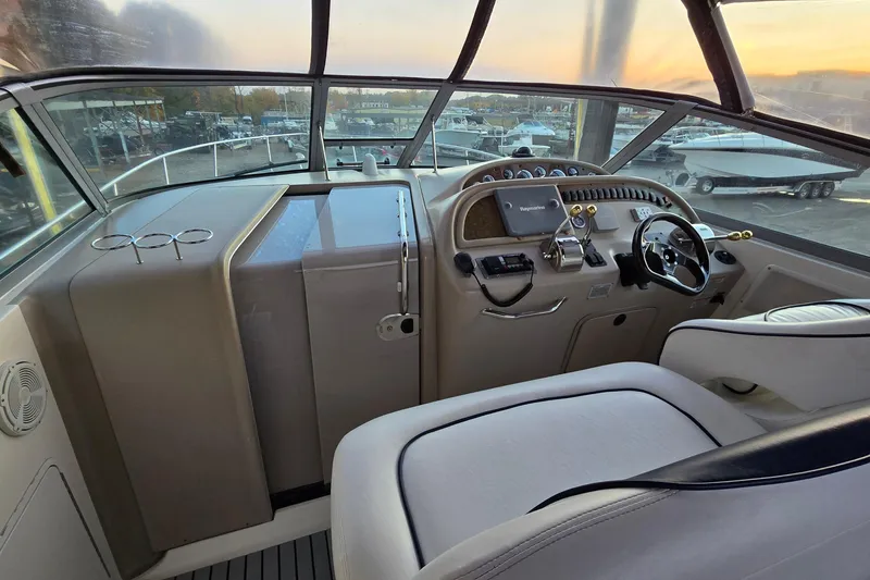 Slide: The Image of Cockpit view of 2001 Sea Ray 310 Sundancer with steering wheel and control panel. - 29