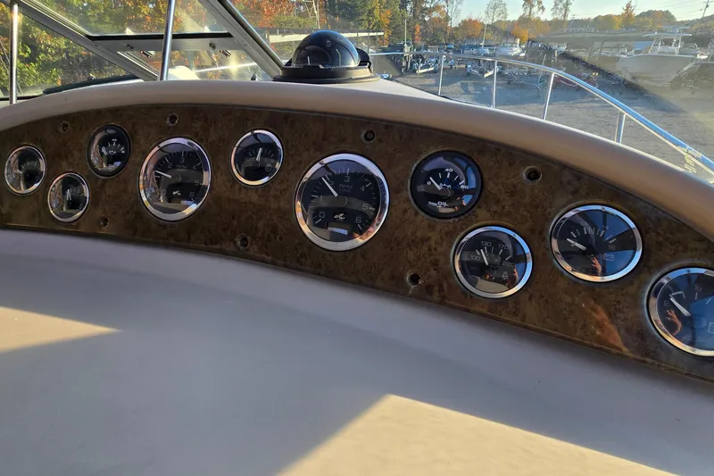 Slide: The Image of Dashboard of 2001 Sea Ray 310 Sundancer with multiple gauges and controls. - 30