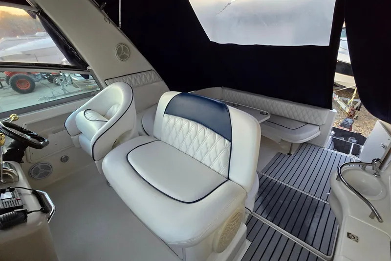 Slide: The Image of Interior of 2001 Sea Ray 310 Sundancer with white seating and modern design. - 34