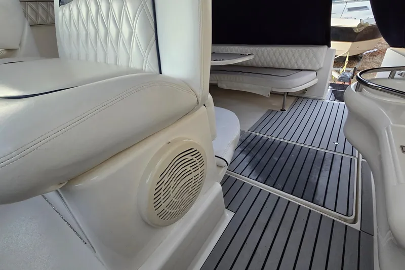 Slide: The Image of Interior of 2001 Sea Ray 310 Sundancer with white seating and striped flooring. - 35
