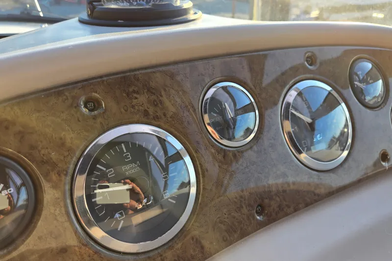Slide: The Image of Dashboard of 2001 Sea Ray 310 Sundancer with RPM and fuel gauges. - 36