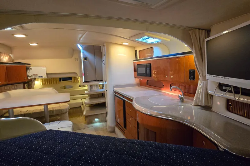 Slide: The Image of Interior of 2001 Sea Ray 310 Sundancer yacht with kitchen, seating, and TV. - 41