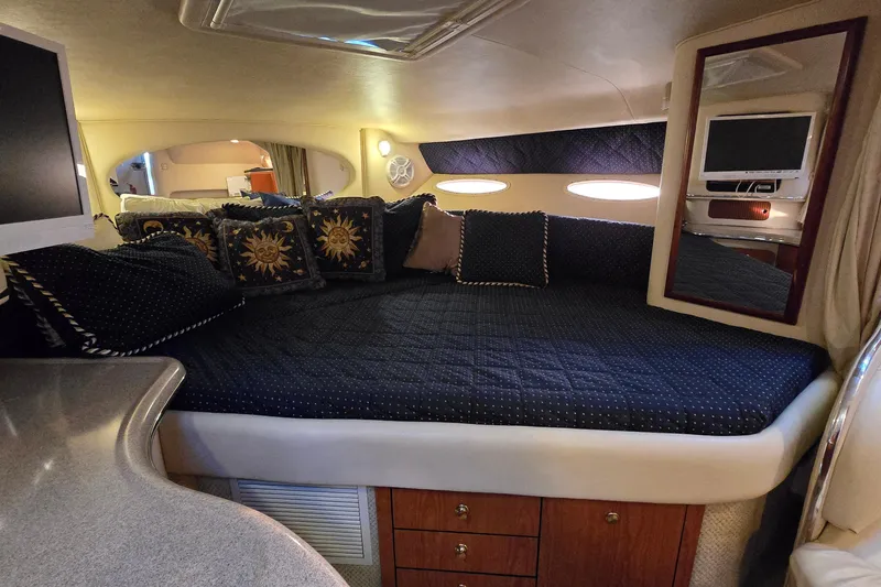 Slide: The Image of Luxurious interior of 2001 Sea Ray 310 Sundancer with cozy bedding and elegant decor. - 46