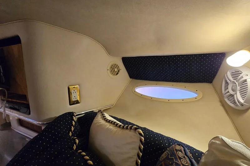 Slide: The Image of Interior of 2001 Sea Ray 310 Sundancer with cozy seating and ambient lighting. - 47