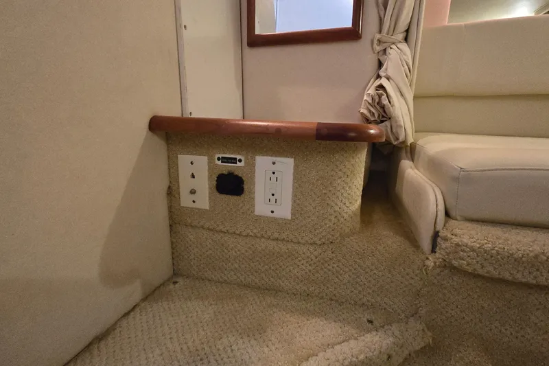 Slide: The Image of Interior of 2001 Sea Ray 310 Sundancer with outlets and carpeted steps. - 58