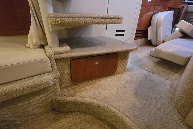 Slide: The Image of Interior of 2001 Sea Ray 310 Sundancer with carpeted steps and storage compartment. - 59