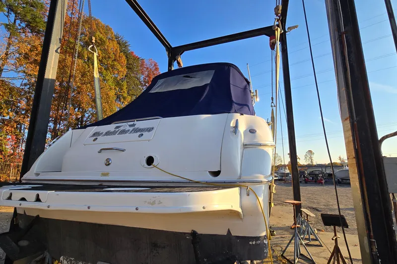 Slide: The Image of 2001 Sea Ray 310 Sundancer boat on lift, autumn trees in background. - 6