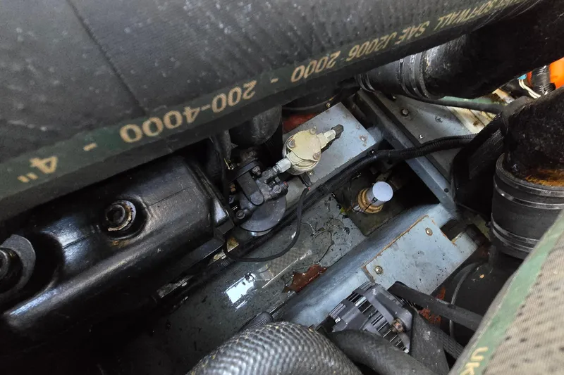 Slide: The Image of Engine compartment of a 2001 Sea Ray 310 Sundancer boat, showing hoses and components. - 60