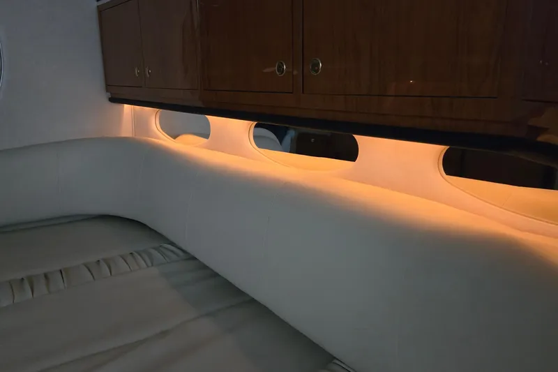 Slide: The Image of Interior cabin of 2001 Sea Ray 310 Sundancer with ambient lighting and wooden cabinets. - 66