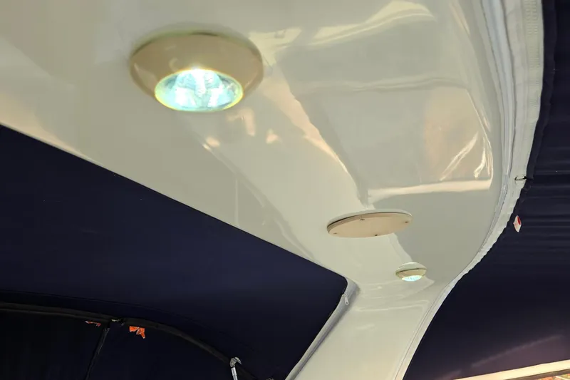 Slide: The Image of Interior lighting of a 2001 Sea Ray 310 Sundancer boat with blue canopy. - 68