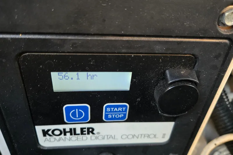 Slide: The Image of Kohler digital control panel showing 56.1 hours on Sea Ray 310 Sundancer, 2001 model. - 70