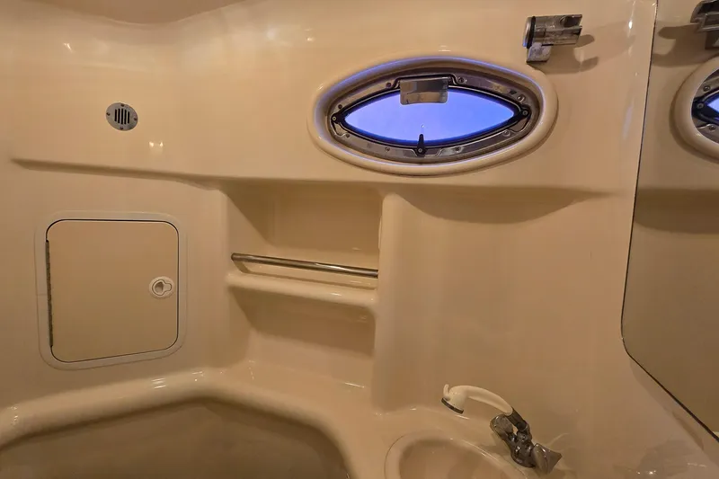 Slide: The Image of Interior of 2001 Sea Ray 310 Sundancer boat bathroom with porthole and sink. - 72