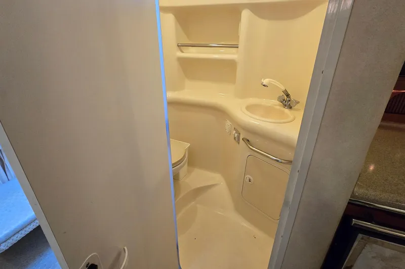 Slide: The Image of Bathroom interior of 2001 Sea Ray 310 Sundancer yacht, featuring sink and toilet. - 74
