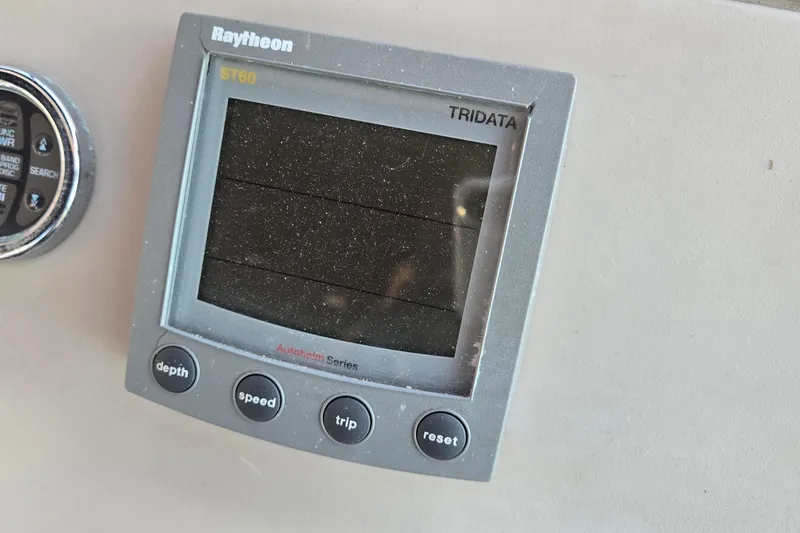Slide: The Image of Raytheon ST60 Tridata display on 2001 Sea Ray 310 Sundancer boat dashboard. - 78