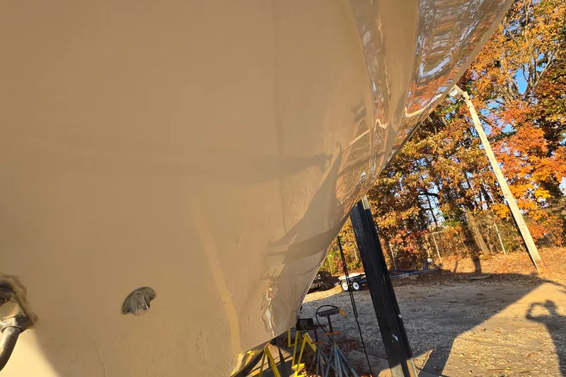 Slide: The Image of Close-up of 2001 Sea Ray 310 Sundancer hull with autumn trees in background. - 8