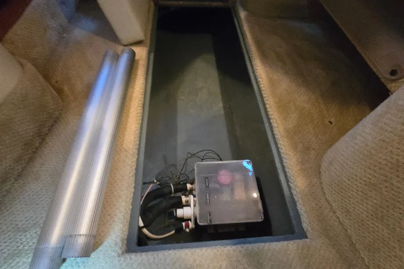 Slide: The Image of 2001 Sea Ray 310 Sundancer interior compartment with wiring and tubing. - 82