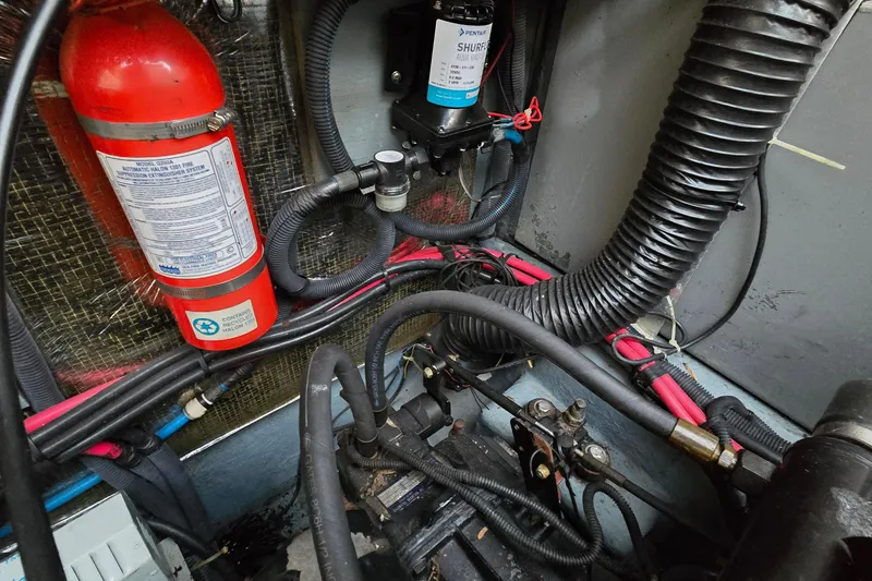 Slide: The Image of Engine compartment of a 2001 Sea Ray 310 Sundancer with fire extinguisher and wiring. - 87
