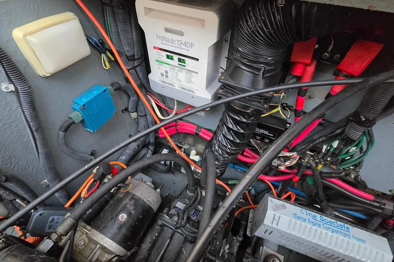Slide: The Image of Engine compartment of a 2001 Sea Ray 310 Sundancer with wiring and ProNautic charger. - 88