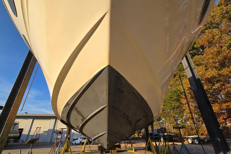 Slide: The Image of 2001 Sea Ray 310 Sundancer boat on dry dock, viewed from the bow. - 9