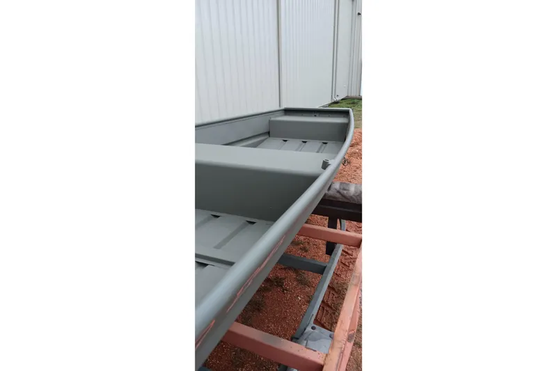 Slide: The Image of 2026 Tracker Grizzly 1436 Jon boat on trailer, side view. - 3