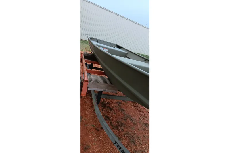 Slide: The Image of 2026 Tracker Grizzly 1436 Jon boat on trailer, outdoor setting. - 6