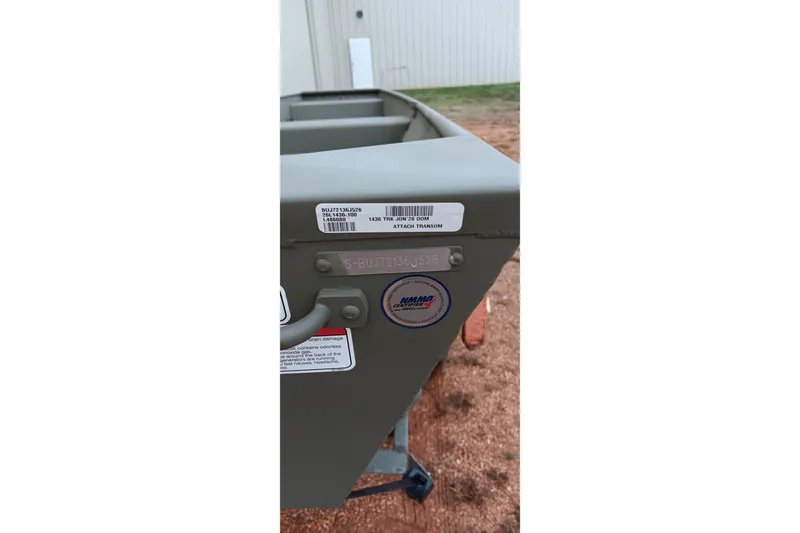 Slide: The Image of 2026 Tracker Grizzly 1436 Jon boat transom with identification labels. - 9