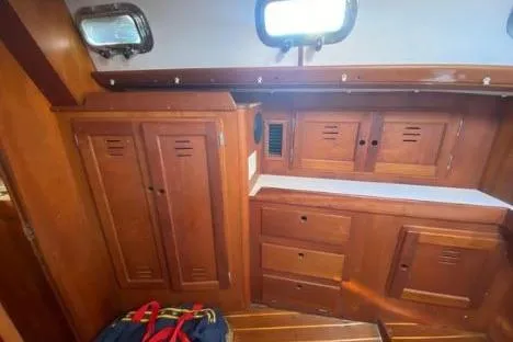 Slide: The Image of Wooden interior of a 1997 Freedom 45 sailboat cabin with storage cabinets. - 11