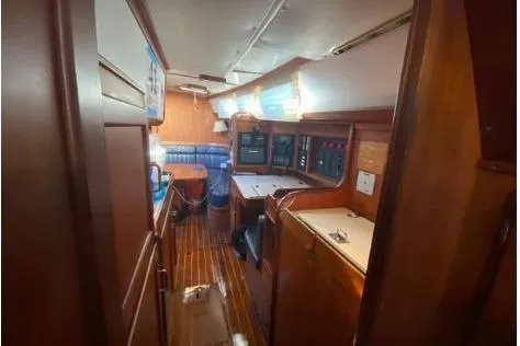Slide: The Image of Interior of 1997 Freedom 45 sailboat with wooden cabinetry and navigation equipment. - 12